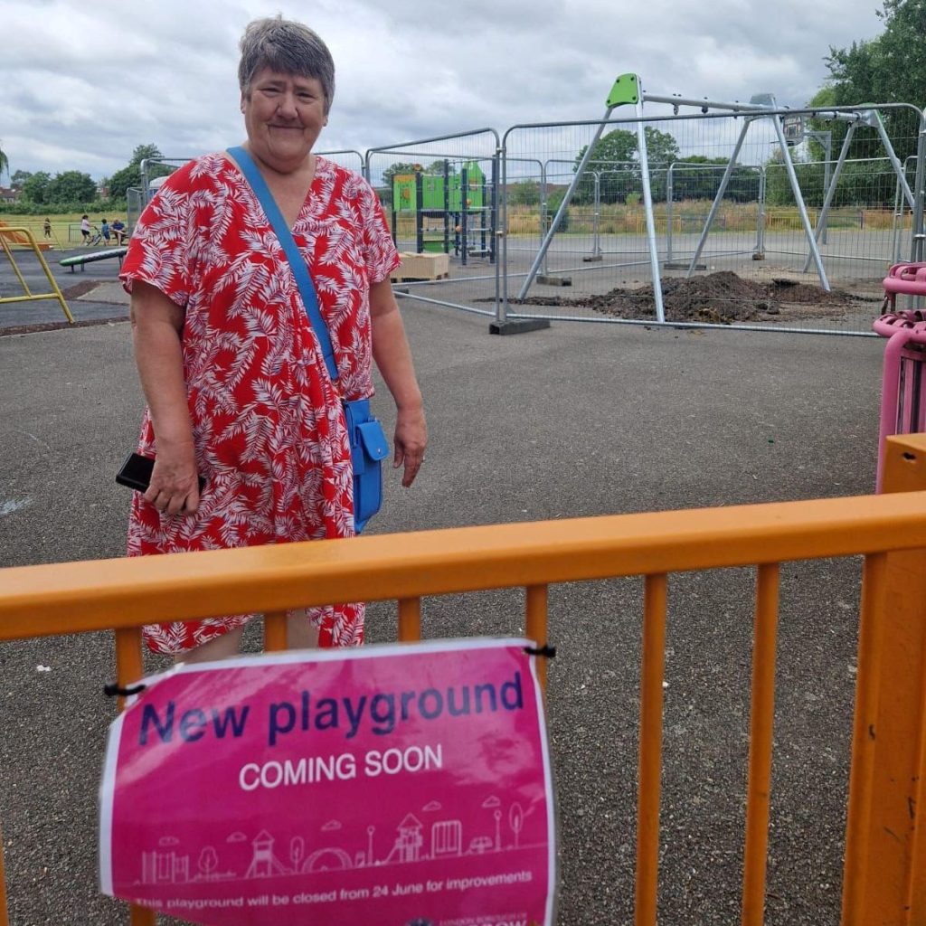 Cllr Maxine Henson on the site of the new playground with new play equipment in the background