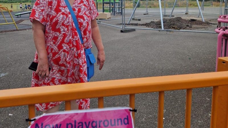 Cllr Maxine Henson on the site of the new playground with new play equipment in the background